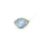 Star Sapphire ring, central high cabochon sapphire, rub set with single cut diamond set shoulders,