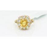 Yellow sapphire and diamond cluster ring, central oval cut yellow sapphire, estimated weight 1.35ct,