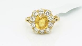 Yellow sapphire and diamond cluster ring, central oval cut yellow sapphire, estimated weight 1.35ct,