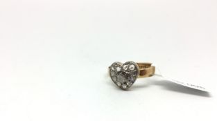 A yellow gold diamond set heart ring. The heart is set with rose cuts and a central brilliant cut