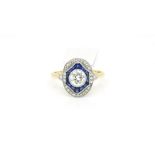 Diamond and sapphire deco style ring, central brilliant cut diamond set with a border of calibre cut