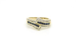 sapphire and diamond cross over ring, channel set sapphires, in 9ct yellow, ring size S