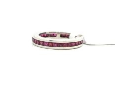 Ruby full eternity ring, calibre cut rubies set to the full hoop, mounted in white metal, ring