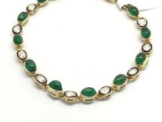 Emerald and diamond bracelet, oval cabochon cut diamonds, spaced with polki diamonds within a enamel