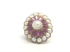 A French, ruby and pearl ring, central 8mm pearl, surrounded by pear cut rubies, and a further