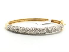 French diamond set clasp bangle, half hoop pavÃ© set round brilliant cut diamonds, mounted in yellow