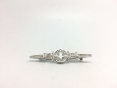 A 14ct white gold diamond set brooch. Approximately 0.60cts of diamonds. 5.8cm wide. 5.9g