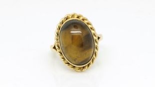 Tigers eye dress ring, cabochon cut tigers eye, heavy rope edge border, in 9ct, ring size Q