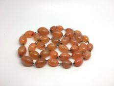 A stine of antique carnelian agate beads, approximately 166g