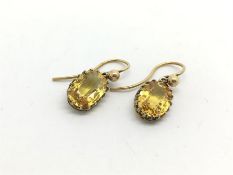 Victorian yellow sapphire earrings, a pair of oval cut yellow sapphires, claw set, suspended from
