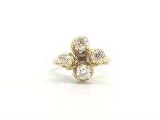 A four stone old cut diamond ring, the old cut diamonds weighing an estimated total of 1.30cts, in a