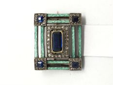 An enamel and sapphire brooch with diamond details. Likely Russian in origin. 19 x 16 mm.