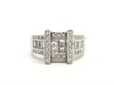 Diamond cluster ring, central set four princess cut diamonds, surrounded by pave set round brilliant