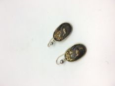 A pair of yellow metal Japanese shakudo earrings depicting a crane under a tree. 8.9g. The panels
