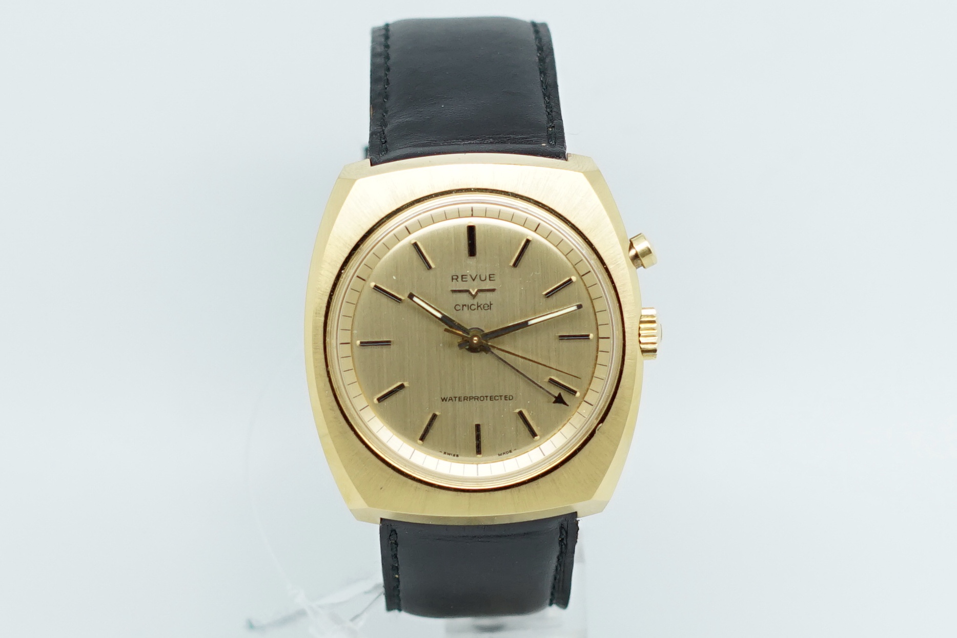 Gentlemen's NOS Revue Cricket Wristwatch, circular brushed champagne dial with gold two tone baton