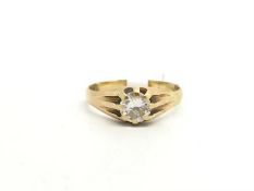 Single stone diamond ring. The diamond weighing approximately 0.90cts in a yellow mount stamped