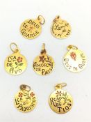 A group of seven gold and enamel miniature medalions, each measures approxiamelty 10mm in