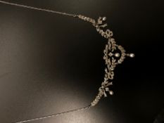 An Edwardian pearl and diamond diamond necklace, diamond necklace, in a bow and leaf design, with