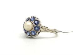 Pearl and sapphire cluster ring, central 5.3mm pearl surrounded by sapphires, mounted in white metal
