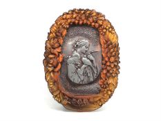 French Amber box, lid depicting a scene of women holding a dove, an outer border of carved floral