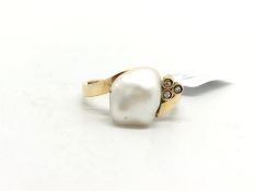 Baroque pearl and diamond ring, set in yellow metal stamped and tested as 14ct, ring size M