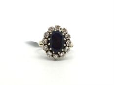 French sapphire and diamond cluster ring, central oval cut sapphire, measuring an estimated 12.2 x