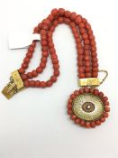 Coral, diamond and enamel bracelet, three rows of coral beads, on a diamond and enamel clasp, with