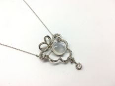 A platinum diamond and moonstone brooch / necklace in a fitted case. French import marks. The old