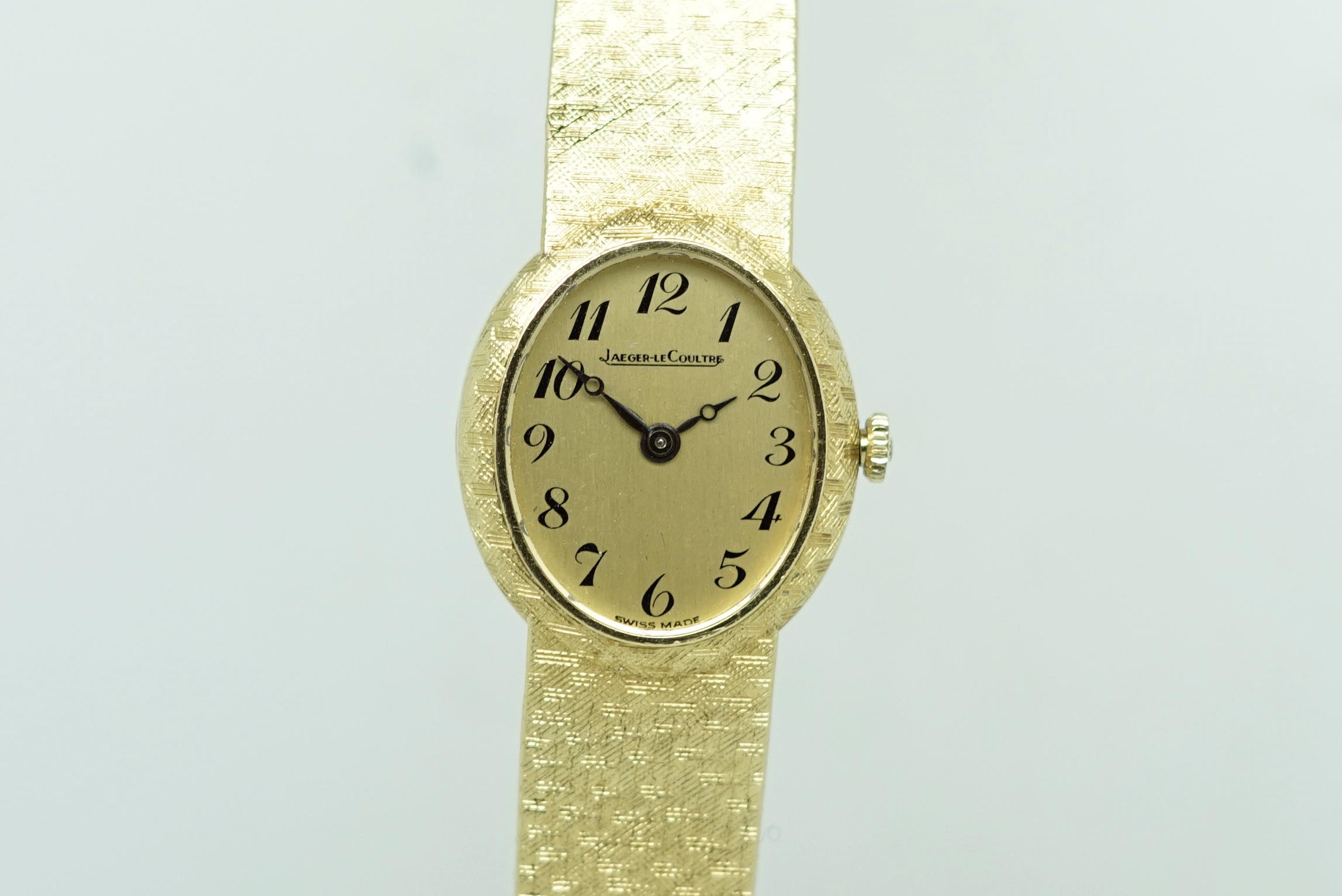 Ladies' Jaeger Le Coultre 18ct Gold Wristwatch, oval gold dial with fancy Arabic numerals, in a