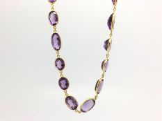 Amethyst necklace, graduated oval cut amethysts, individually set with chain link detail, in 18ct