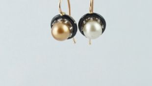 A pair of pearl and enamel earrings, 'day and night' design, 7.3mm pearl surrounded by black enamel,