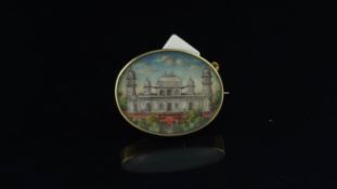 Painted miniature, oval painted image of a building in a yellow metal frame, tested as 18ct,