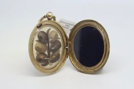 Edwardian locket, oval, engraved floral design, with hair locket inside, measures 40 x 30mm