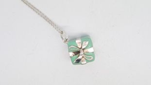 TIFFANY & CO- An enamel and silver present pendant and chain, both signed, chain approximately 45cm
