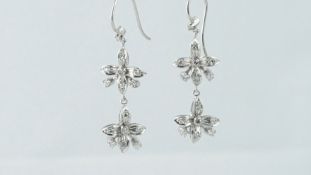 Pair of diamond drop earrings, designed as two diamond set flower drops, on a French wire