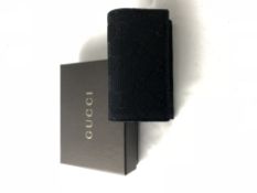 GUCCI- A black GG Monogram canvas coin purse in or