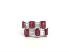 Ruby and diamond cocktail ring, six rectangular cut rubies set with baguette cut diamonds in a cross