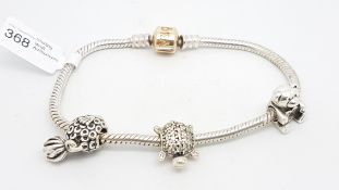 PANDORA- A Pandora charm bracelet with a 14ct gold clasp and three charms, length approximately