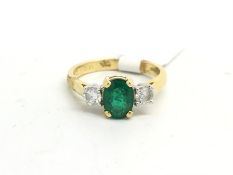 Emerald and diamond three stone ring, central oval cut emerald weighing 1.02ct, with a round
