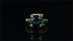 Green stone ring, cabochon cut green stone, with demantoid garnets set to the claws, gallery and