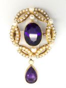 An amethyst and pearl pendant/brooch, central oval cut amethyst, surrounded by seed pearls,