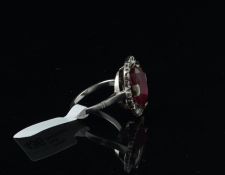 Ruby and diamond cluster ring, central ruby, surrounded by round brilliant cut diamonds, in white