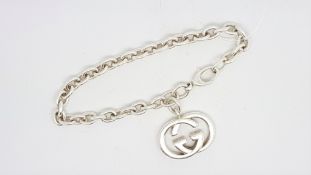 GUCCI- A Gucci bracelet, belcher links with Gucci emblem charm, signed to clasp, sterling silver,