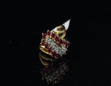 Ruby and diamond ring, twist design with five central round brilliant cut diamonds and surrounded by