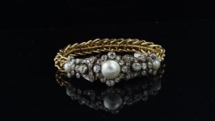 A pearl and diamond bracelet, central 10.8mm bouton pearl, surrounded by old cut diamonds, with