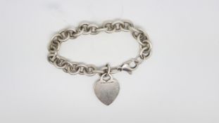 TIFFANY & CO- A silver charm bracelet, with a silver heart charm, signed and hallmarked Tiffany