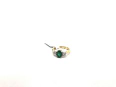Emerald and diamond three stone ring, central oval cut emerald weighing 1.02ct, with a round