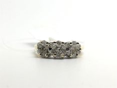 Diamond cluster ring, three diamond daisy clusters set in a row, in white metal on an 18ct yellow