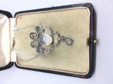 A platinum diamond and moonstone brooch / necklace in a fitted case. French import marks. The old