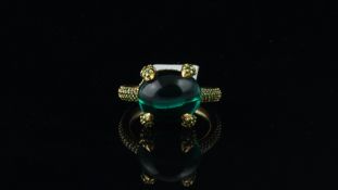 Green stone ring, cabochon cut green stone, with demantoid garnets set to the claws, gallery and